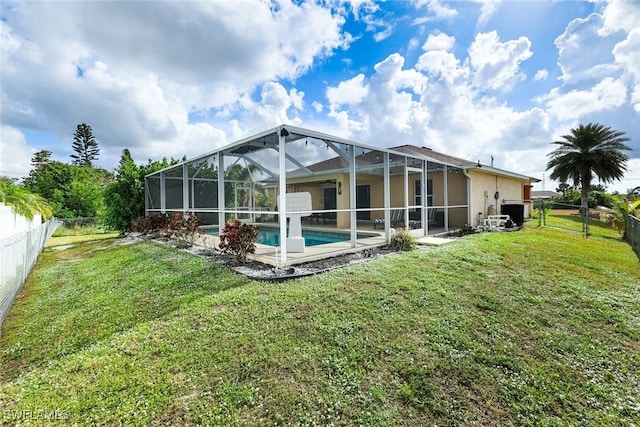 back of house featuring a fenced in pool, central AC unit, a lanai, and a lawn