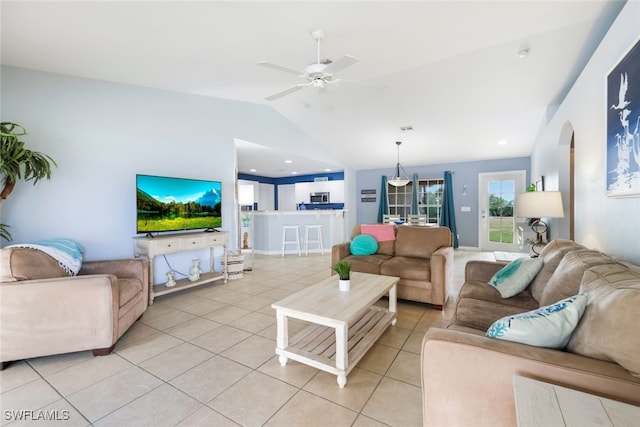 tiled living room with ceiling fan and vaulted ceiling