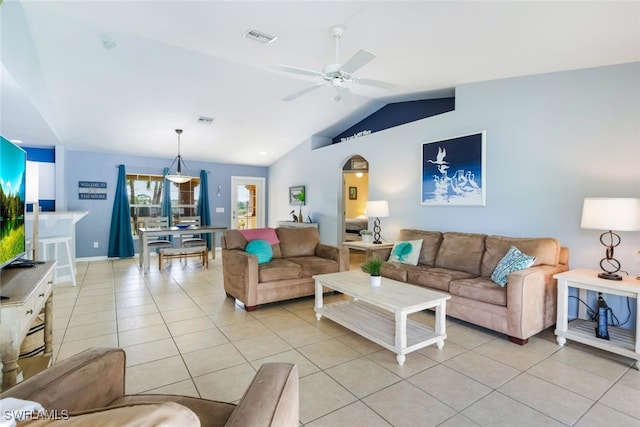 living room with ceiling fan, light tile patterned floors, and vaulted ceiling