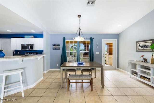 dining space featuring light tile patterned floors