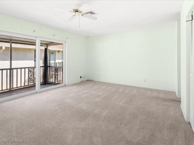 carpeted spare room featuring ceiling fan