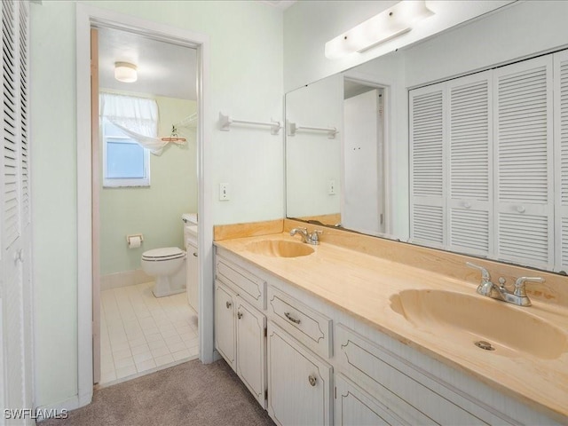 bathroom with tile patterned floors, vanity, and toilet