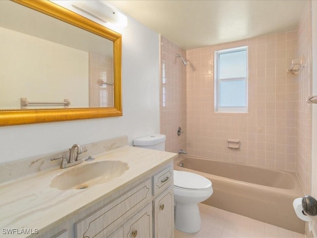 full bathroom featuring vanity, tile patterned floors, tiled shower / bath combo, and toilet