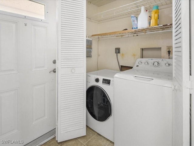 laundry room with washing machine and dryer and light tile patterned floors