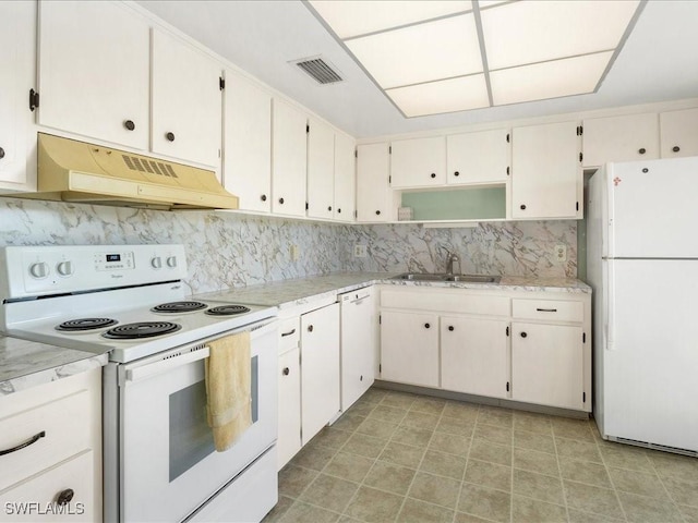 kitchen with white cabinets, decorative backsplash, white appliances, and sink