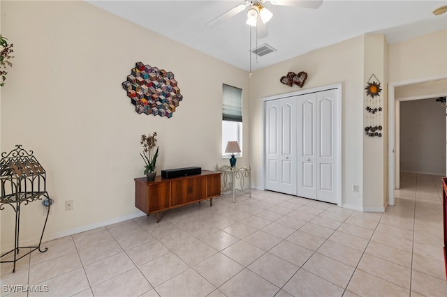 entryway featuring ceiling fan and light tile patterned flooring