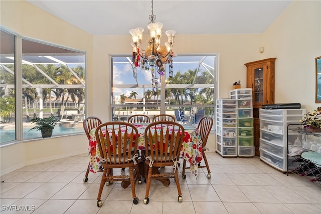 dining space with a notable chandelier and light tile patterned floors