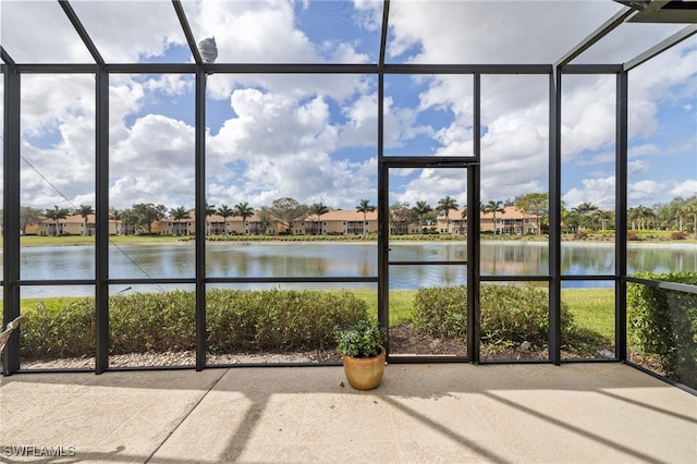 unfurnished sunroom featuring a healthy amount of sunlight and a water view