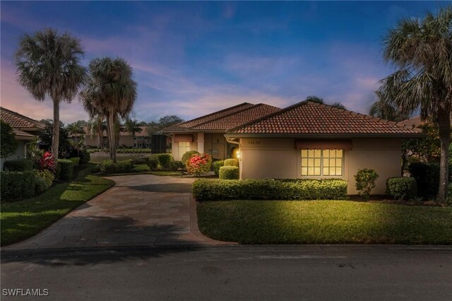 mediterranean / spanish house with a yard