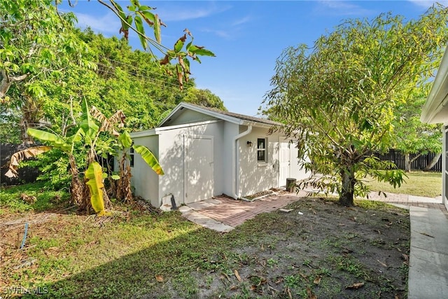 view of outbuilding featuring a lawn