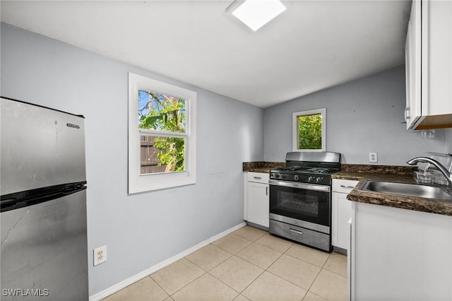 kitchen featuring a healthy amount of sunlight, white cabinetry, sink, and stainless steel appliances