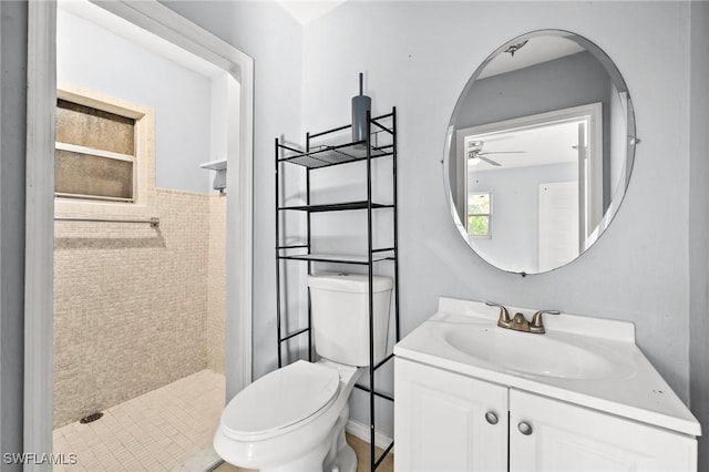 bathroom featuring ceiling fan, toilet, a shower, and vanity