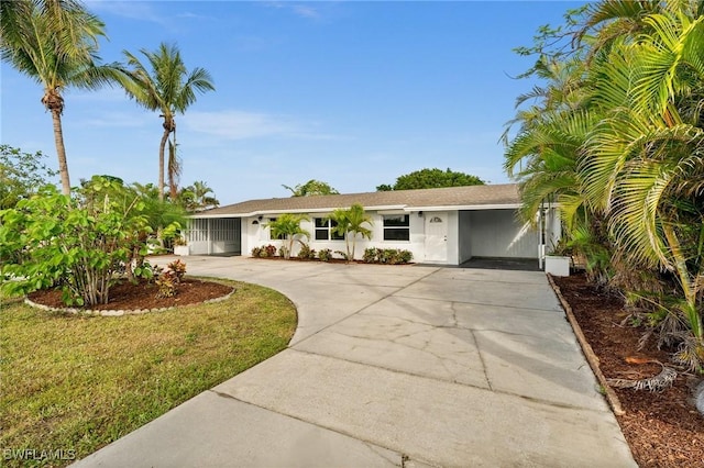 ranch-style house with a carport and a front lawn