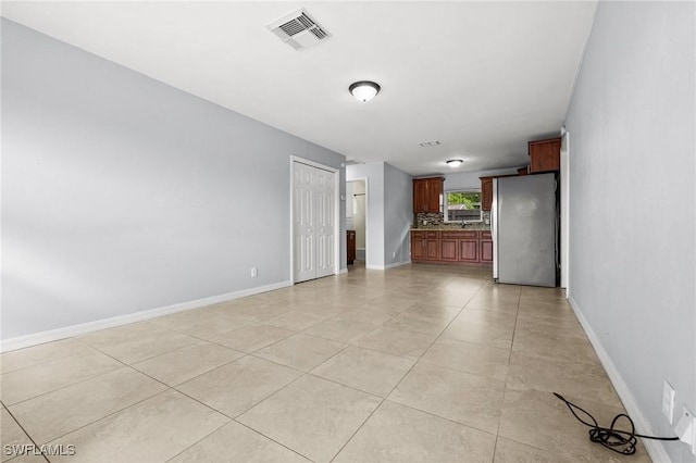 unfurnished living room featuring light tile patterned floors