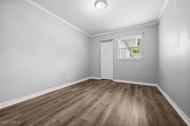 spare room with crown molding and wood-type flooring