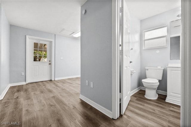 bathroom with toilet and wood-type flooring