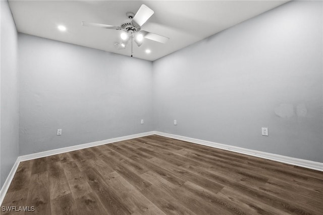 spare room with ceiling fan and dark hardwood / wood-style floors