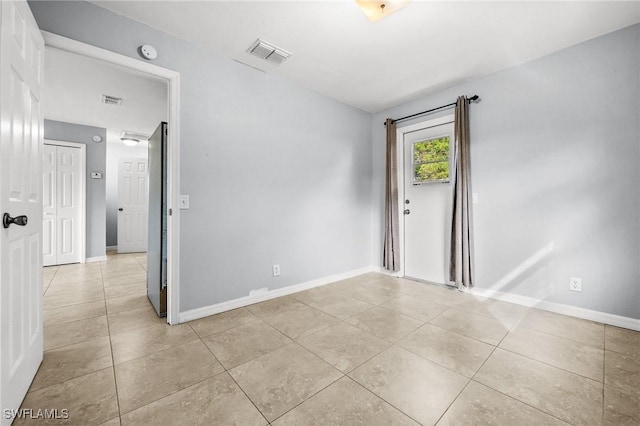 spare room with light tile patterned floors