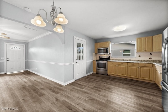 kitchen featuring appliances with stainless steel finishes, dark hardwood / wood-style flooring, light stone counters, crown molding, and pendant lighting