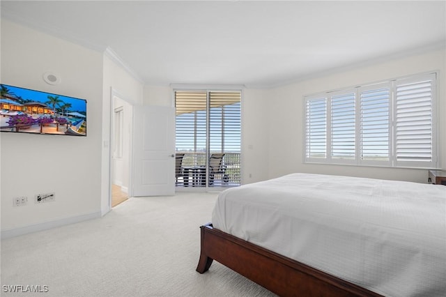 carpeted bedroom with multiple windows, ornamental molding, and access to exterior