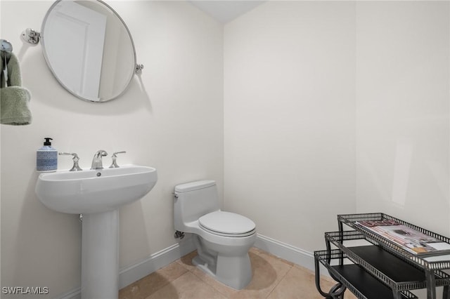 bathroom featuring tile patterned flooring and toilet