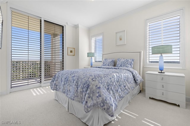 bedroom featuring access to exterior, crown molding, and carpet floors