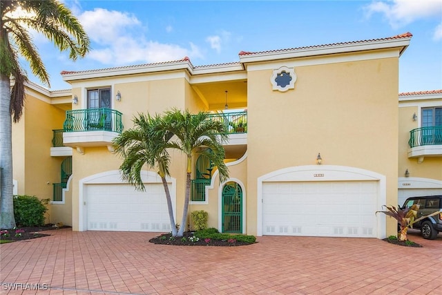 mediterranean / spanish home with a balcony and a garage