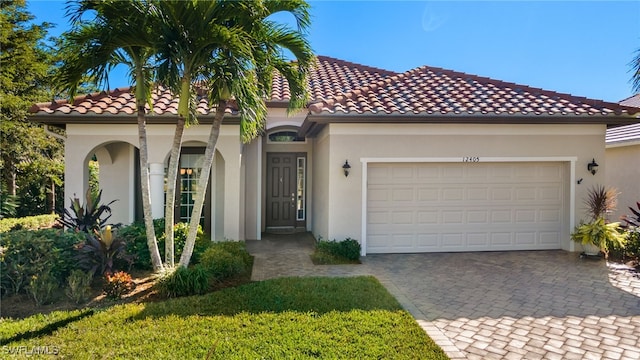 mediterranean / spanish-style home with a garage