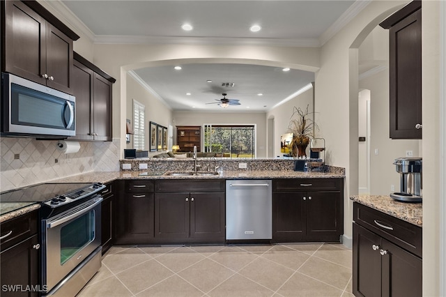 kitchen featuring appliances with stainless steel finishes, dark brown cabinetry, ceiling fan, sink, and light tile patterned flooring