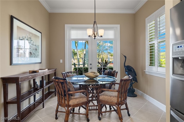 dining space featuring light tile patterned flooring, crown molding, and a chandelier