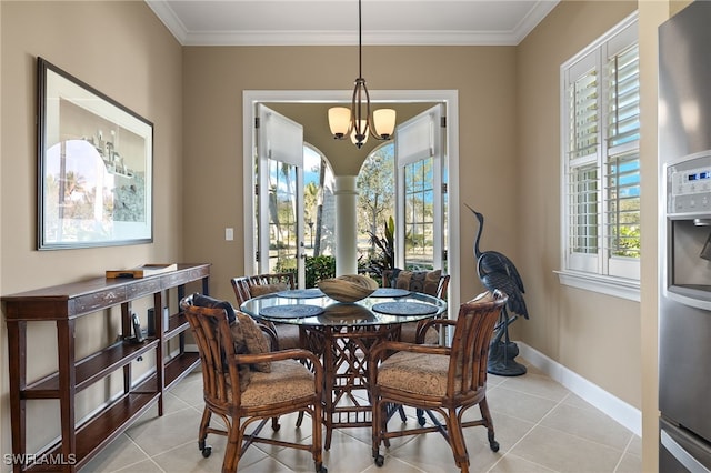 tiled dining room with a chandelier and ornamental molding