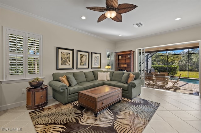 living room with ceiling fan, light tile patterned floors, and crown molding