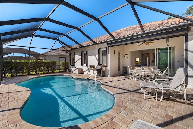 view of pool featuring area for grilling, a patio area, ceiling fan, and a lanai