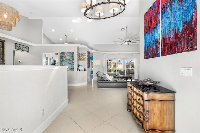 corridor featuring high vaulted ceiling, a chandelier, and light tile patterned floors