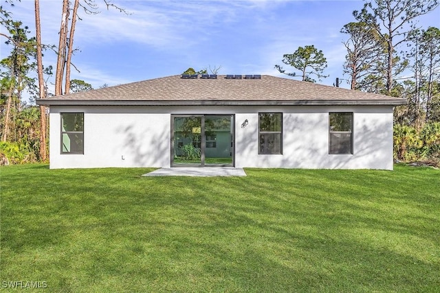 3226 NW 3rd Pl, Cape Coral, FL 33993 - back of property with a lawn, stucco siding, and roof with shingles