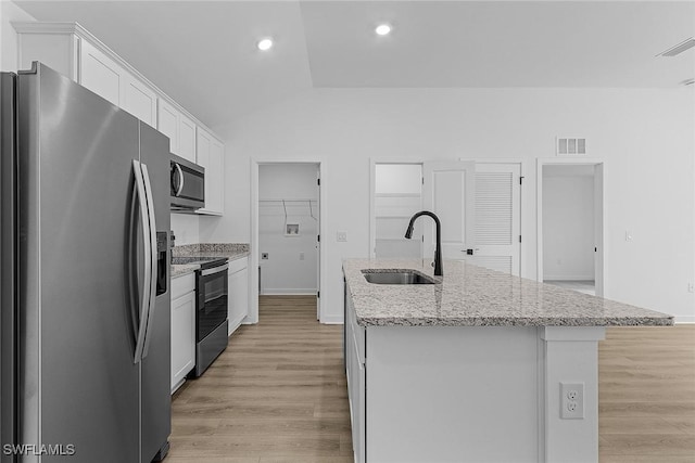 3226 NW 3rd Pl, Cape Coral, FL 33993 - kitchen featuring appliances with stainless steel finishes, a sink, an island with sink, white cabinets, and light wood-style floors