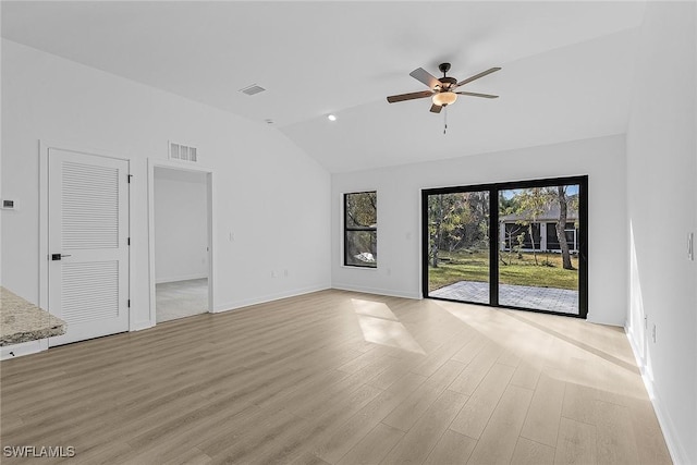 3226 NW 3rd Pl, Cape Coral, FL 33993 - unfurnished living room with vaulted ceiling, a ceiling fan, light wood-style flooring, and baseboards