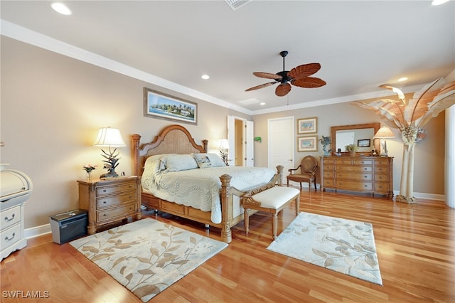 bedroom featuring light wood-type flooring, ceiling fan, and ornamental molding