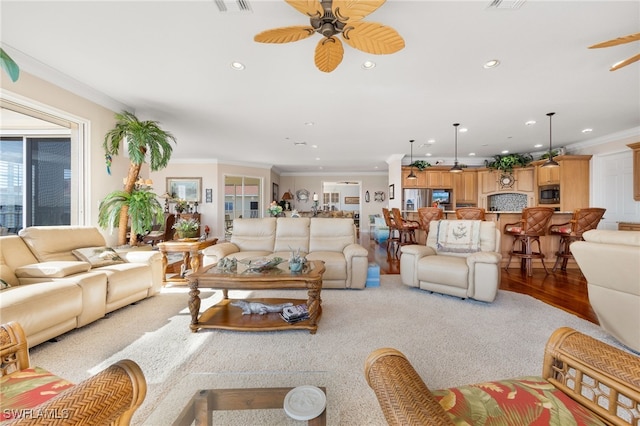 living room featuring crown molding and ceiling fan