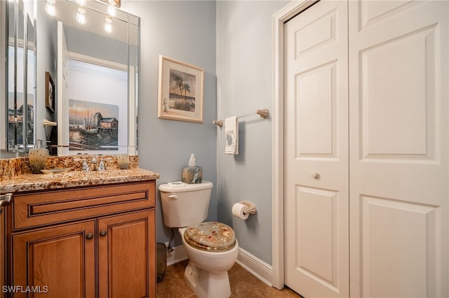 bathroom featuring tile patterned floors, vanity, and toilet