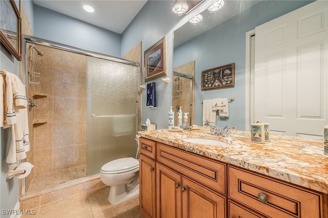 bathroom with tile patterned floors, vanity, toilet, and an enclosed shower