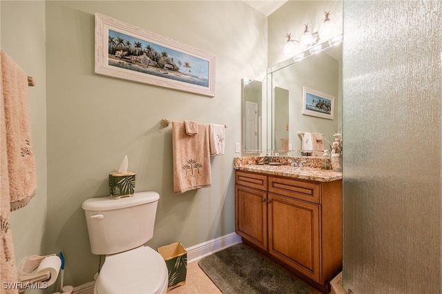 bathroom with tile patterned floors, vanity, and toilet