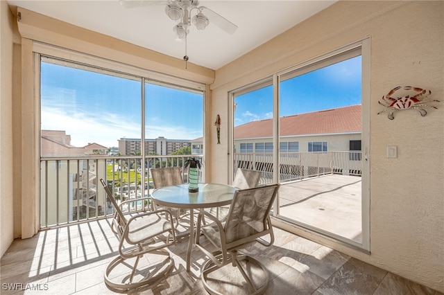 sunroom with ceiling fan and plenty of natural light