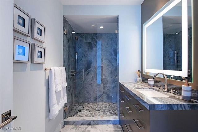 bathroom featuring vanity and tiled shower