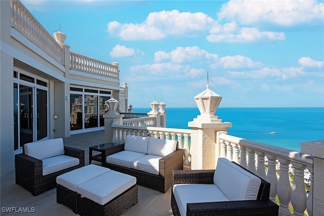 balcony with a water view and outdoor lounge area