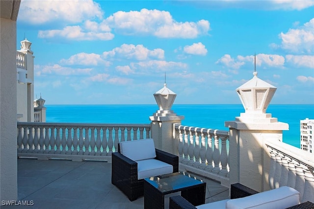 view of patio / terrace featuring a balcony and a water view