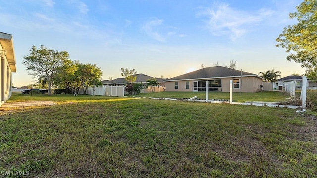 view of yard at dusk