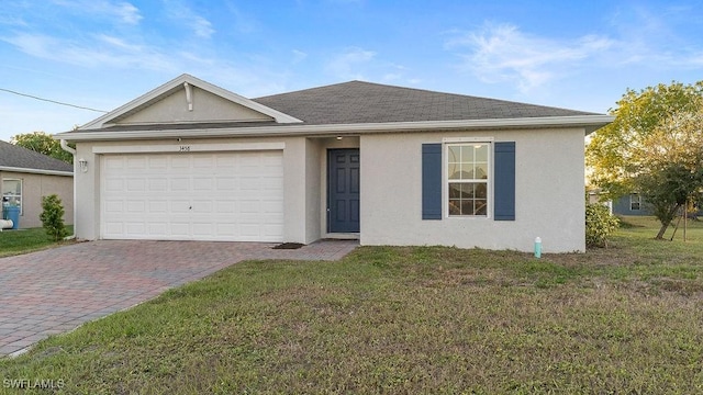 single story home with a garage and a front lawn