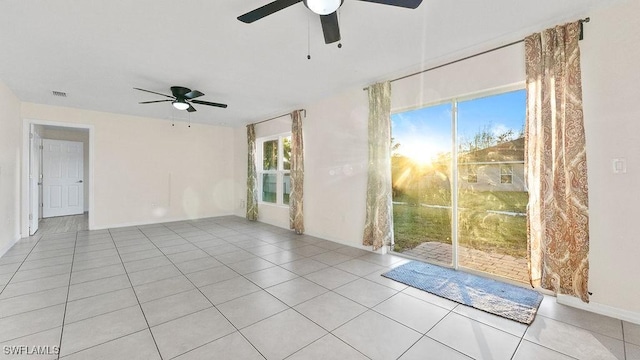 spare room featuring light tile patterned floors and ceiling fan