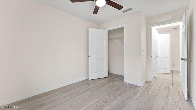 unfurnished bedroom with ceiling fan, a closet, and light hardwood / wood-style flooring